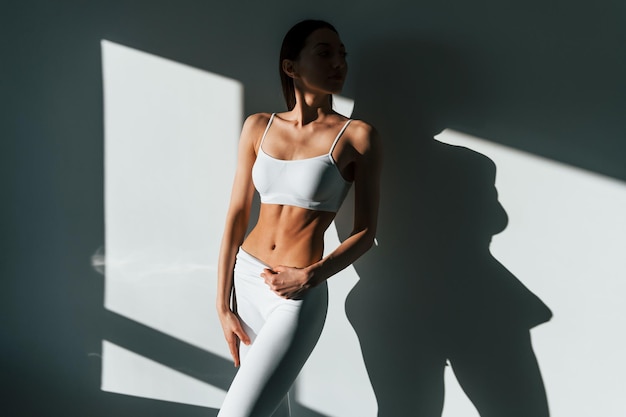 Beautiful lighting Young caucasian woman with slim body shape is indoors at daytime