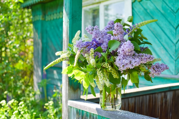 beautiful lilac flowers in basket outdoor  summer. Botanical natural background