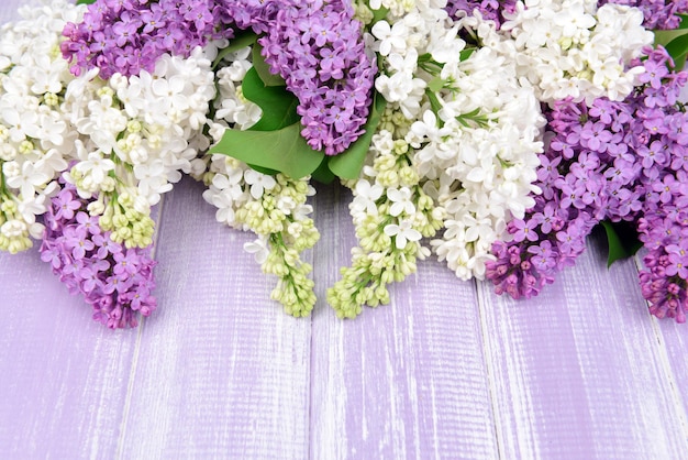 Beautiful lilac flowers on wooden background