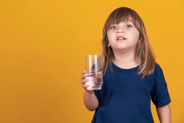 Beautiful little caucasian girl drinking water Hydration and health concept