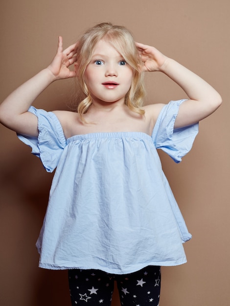 Beautiful little girl blonde curly hair, emotions