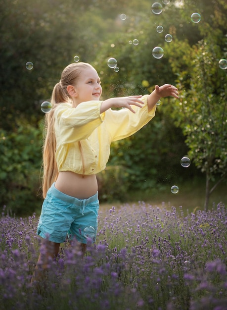 Beautiful little girl in a field with lavender