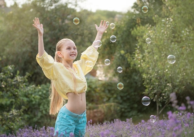 Beautiful little girl in a field with lavender