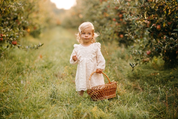 a beautiful little girl in the orchard