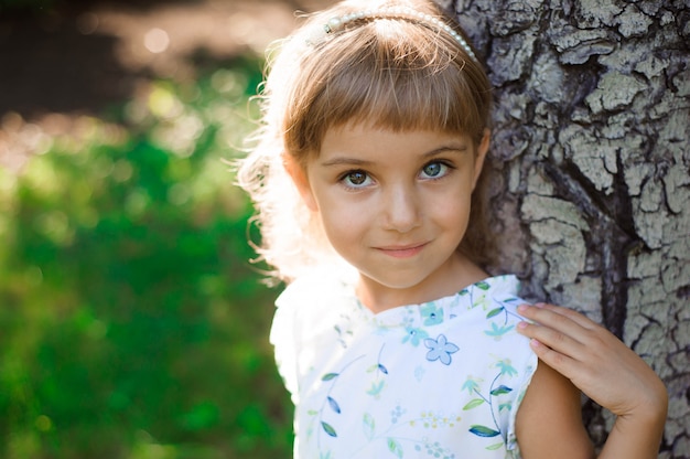 Beautiful little girl outdoor. A happy childhood.