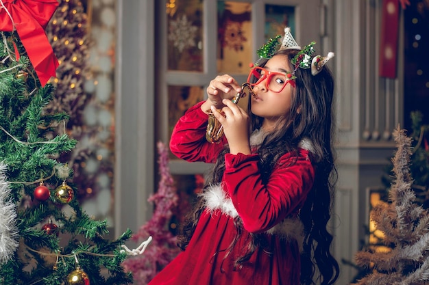 Beautiful little girl partying christmas at home