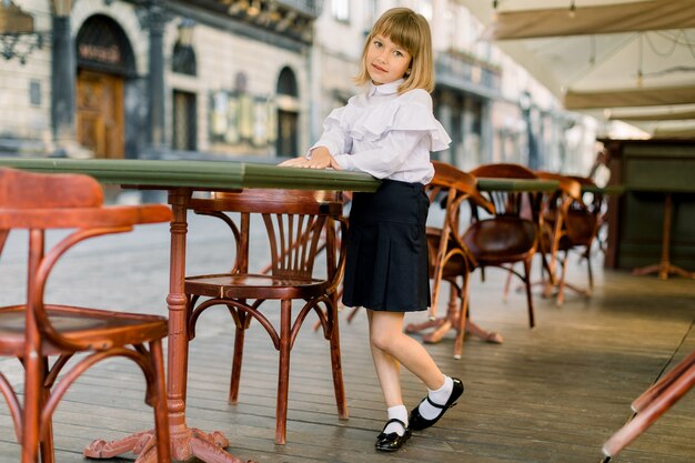 Beautiful little girl in white and black business elegant clothes