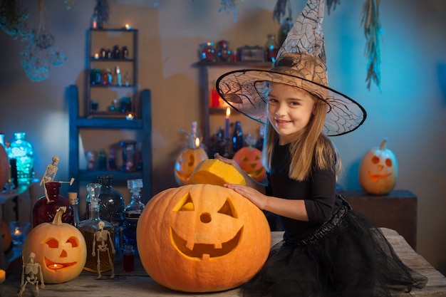 Beautiful little girl in witch costume for Halloween