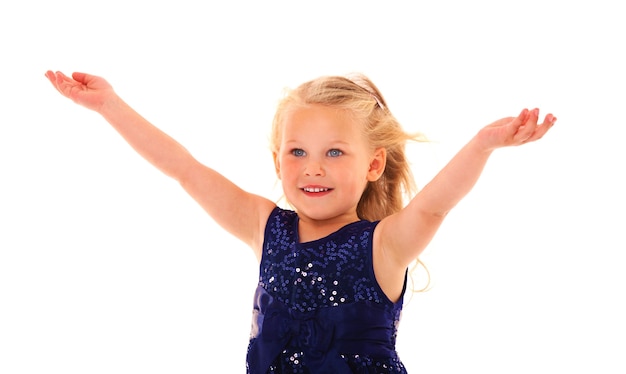 a beautiful little girl with her arms up smiling over white