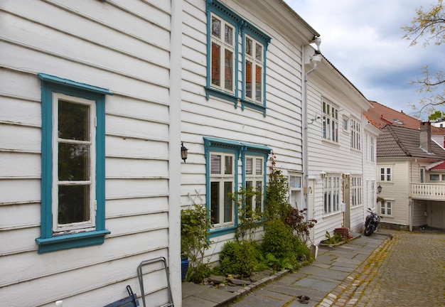 Beautiful little street with traditional Norwegian white houses in Bergen, Norway