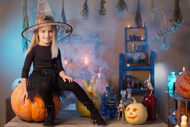 Beautiful little witch with Halloween decorations