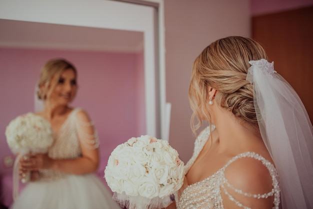 A beautiful lovely brunette bride getting ready in the morning in the room