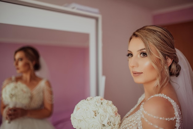 A beautiful lovely brunette bride getting ready in the morning in the room