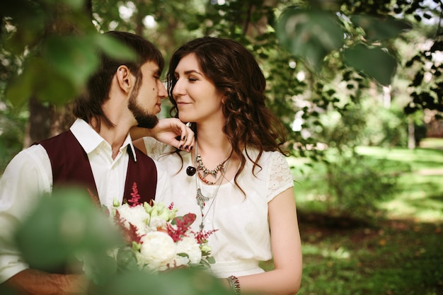 Beautiful loving couple dressed in boho chic style