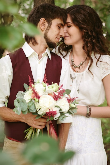 Beautiful loving couple dressed in boho chic style