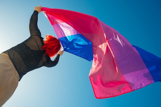 Beautiful low angle shot of a female waving red and blue flag