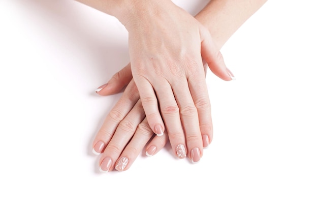 Beautiful manicure Hands of a woman on a white background