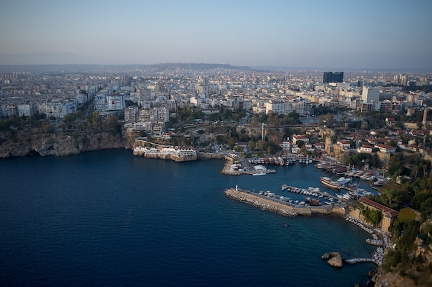 Beautiful Mediterranean seascape in Turkey. Panoramic view of sea coast with buildings on shore. Boats and yachts anchored at harbor in sea bay.