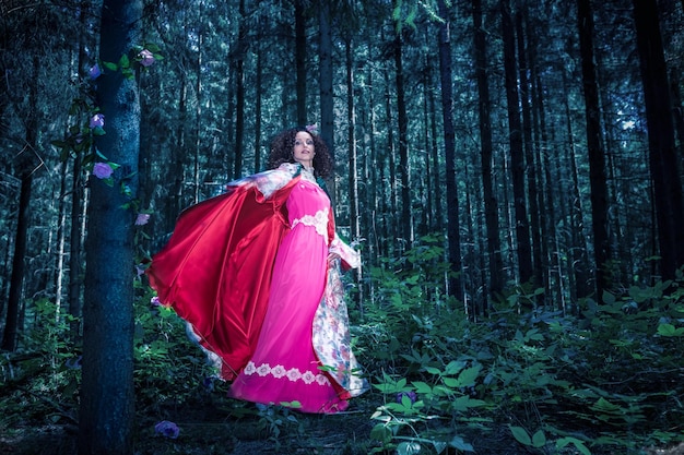 Beautiful mid adult woman wearing traditional clothing while standing in forest