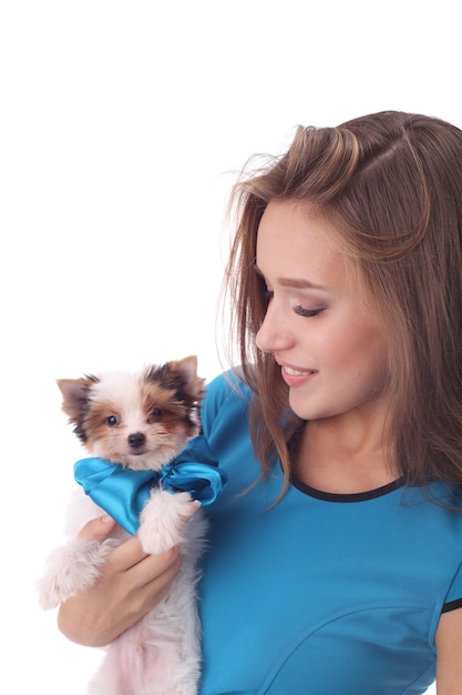 Beautiful model girl wearing blue dress with the cute little beaver puppy