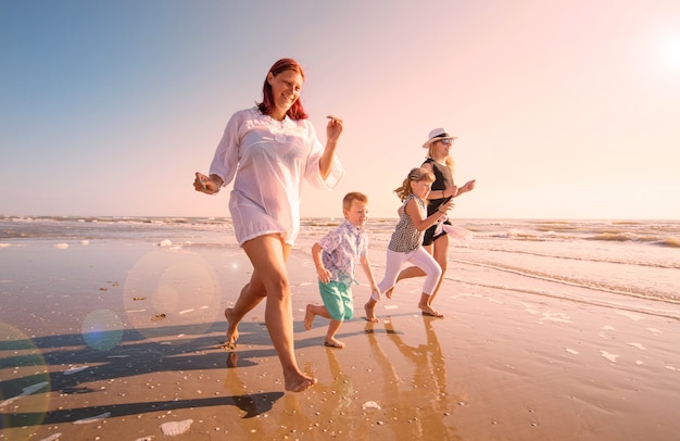 beautiful mom play with her children in the sea