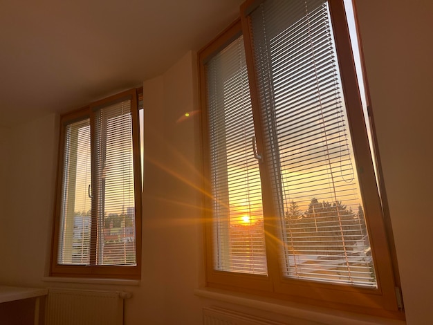 Beautiful morning sun shining through window blinders in the bedroom