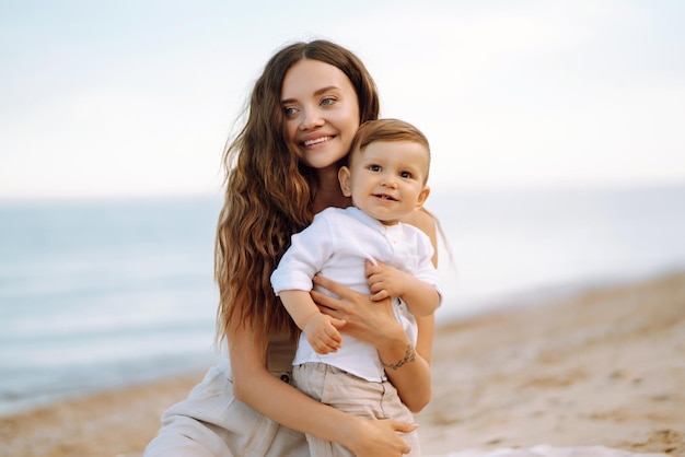 Beautiful mother and child resting on the beach Active lifestyle Happy childhood