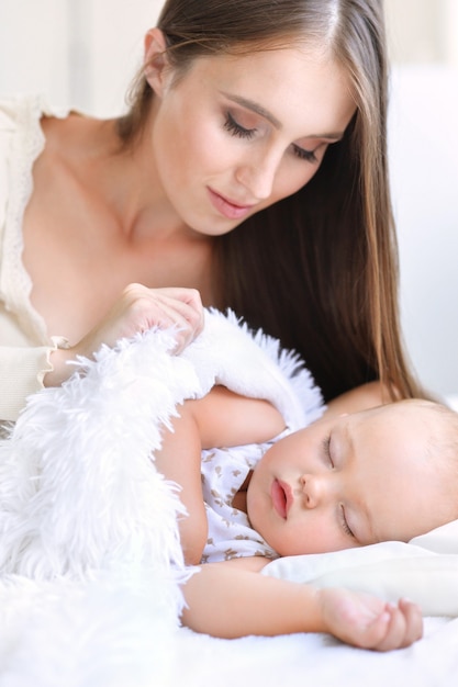 Beautiful  mother and cute child in bed