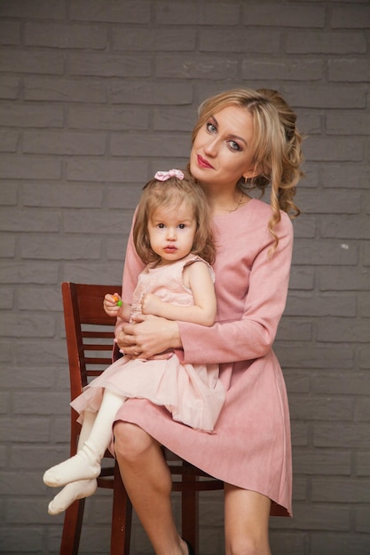 Beautiful mother and daughter in pink dresses