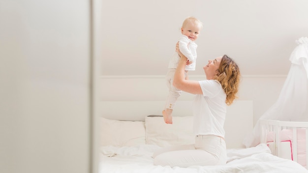 Beautiful mother playing with her baby