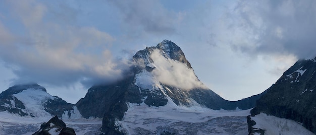 Beautiful mountain Dent Blanche in snow covered with grey clouds Switzerland