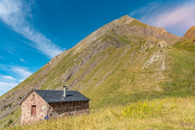 Beautiful mountain landscape with a tiny house Scenic view of a colorful sky above the mountains