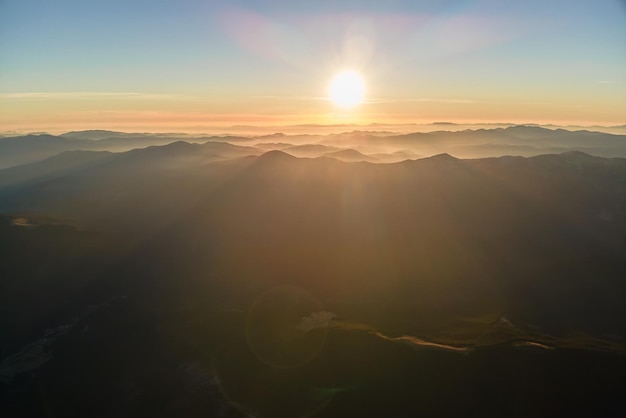 Beautiful mountain panoramic landscape with hazy peaks and foggy valley at sunset