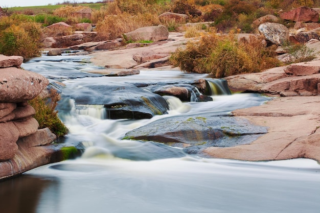 Beautiful mountain river flowing over rocks Flow of water in mountain river close up