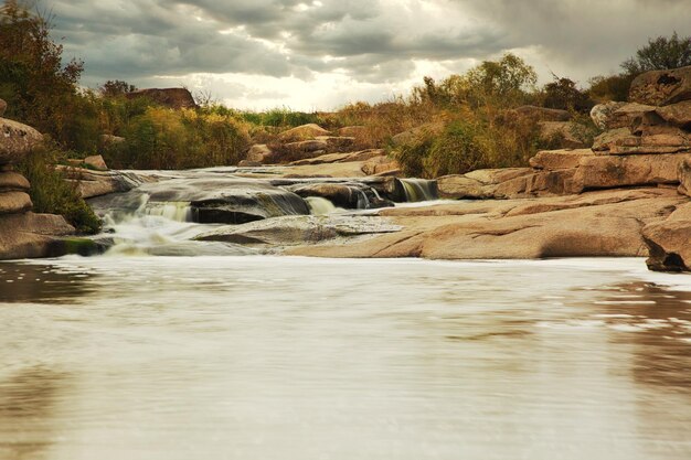 Beautiful mountain river flowing over rocks Flow of water in mountain river close up