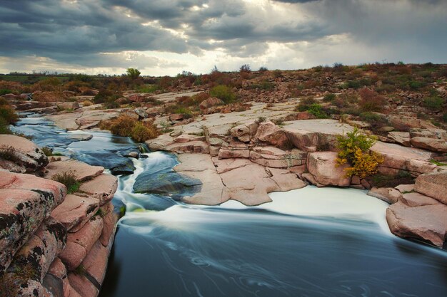 Beautiful mountain river flowing over rocks Flow of water in mountain river close up