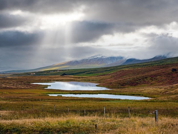 Beautiful mountain view during auto trip in Iceland Spectacular Icelandic landscape with scenic nature mountains fields clouds lakes glaciers