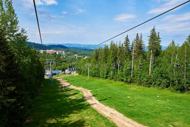 Beautiful mountains covered with forest and open cable car line karpacz resort in poland with lift r