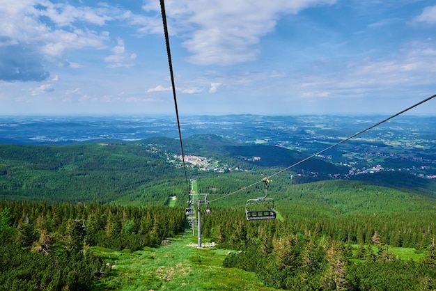 Beautiful mountains covered with forest and open cable car line karpacz resort in poland with lift r