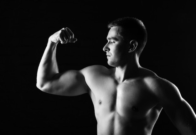 Beautiful and muscular black man's back in dark background