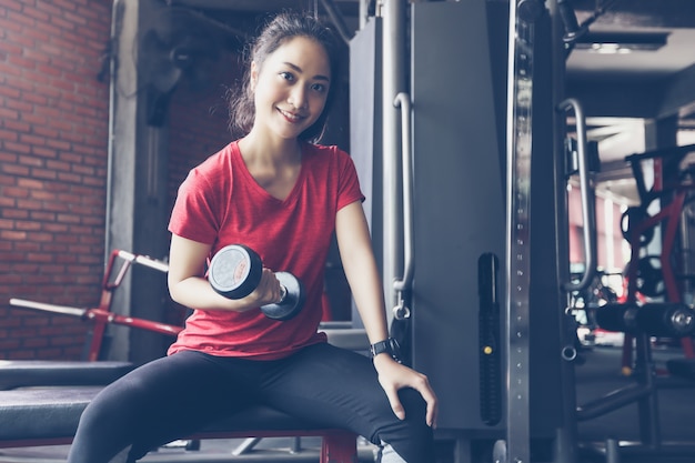 beautiful muscular fit woman exercising building muscles