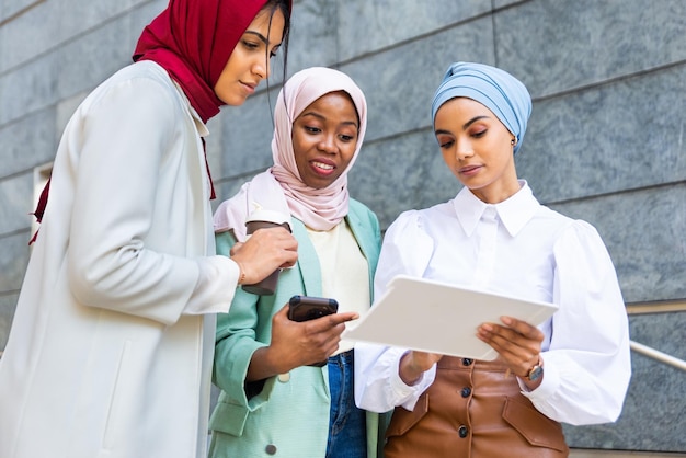 Beautiful muslim girl wearing hijab bonding outdoors