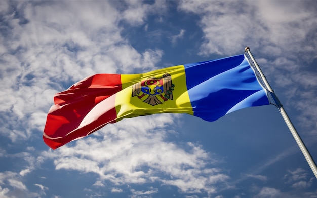 Beautiful national state flag of Moldova fluttering on blue sky