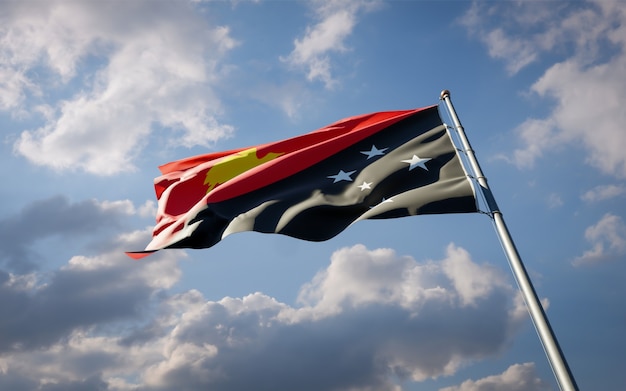 Beautiful national state flag of Papua New Guinea fluttering on blue sky