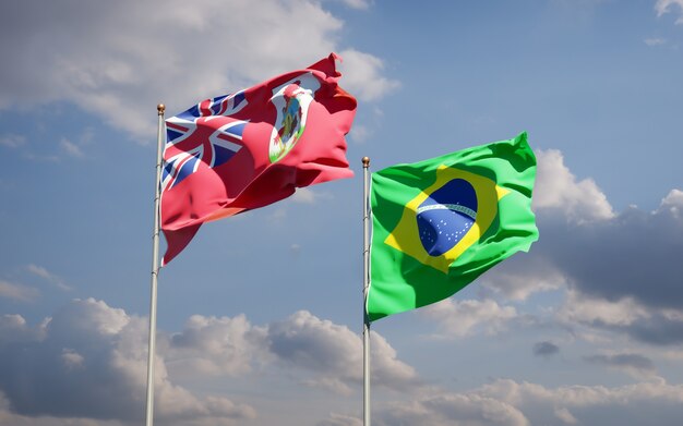 Beautiful national state flags of Brasil and Bermuda together on blue sky