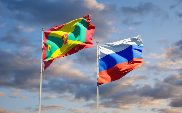 Beautiful national state flags of Grenada and Russia together on blue sky. 3D artwork