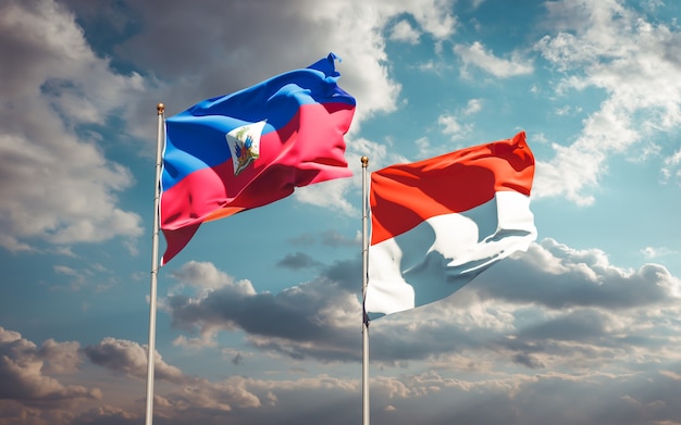 Beautiful national state flags of Haiti and Indonesia together on blue sky