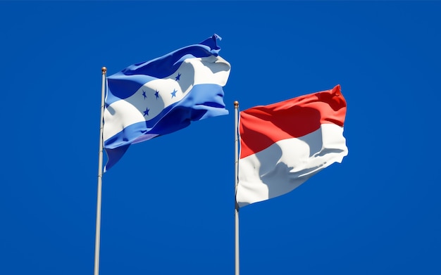 Beautiful national state flags of Honduras and Indonesia together on blue sky