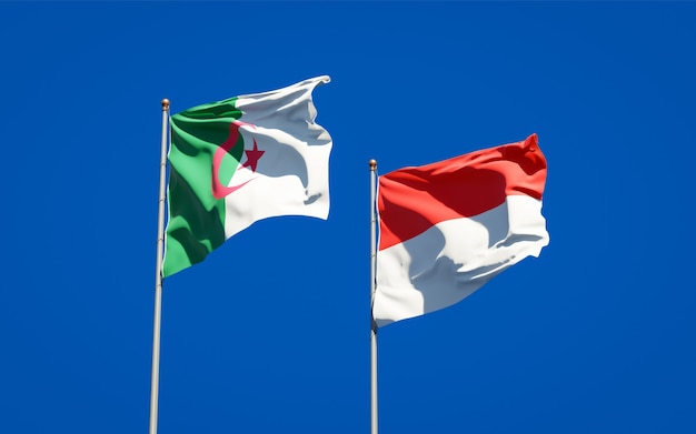 Beautiful national state flags of Indonesia and Algeria together on blue sky