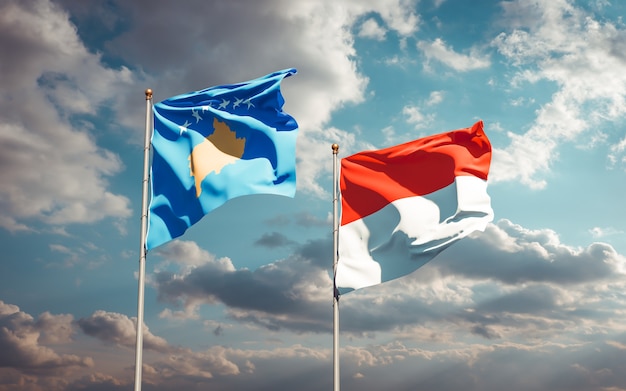 Beautiful national state flags of Kosovo and Indonesia together on blue sky